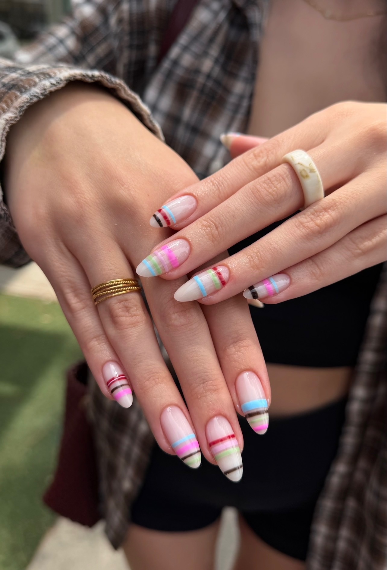 Nude nails with colorful striped French tips
